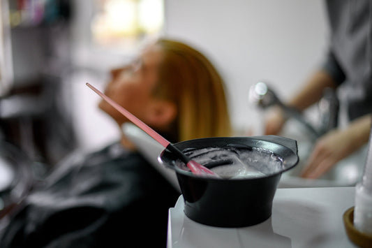 Hair coloring tools and a mixing bowl used during professional hair coloring services at Brilliant Gems Hair Studio in Boerne, TX