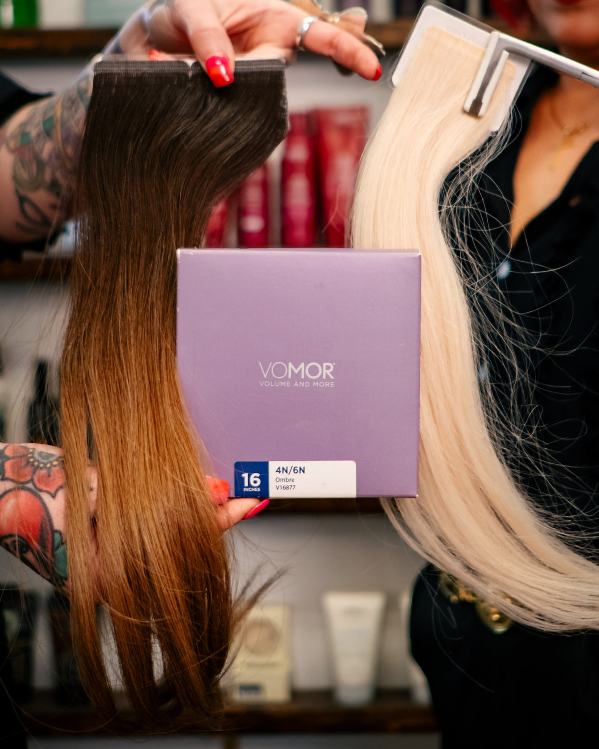 VoMor tape-in hair extension wefts being color matched at Brilliant Gems Hair Studio in Boerne, TX